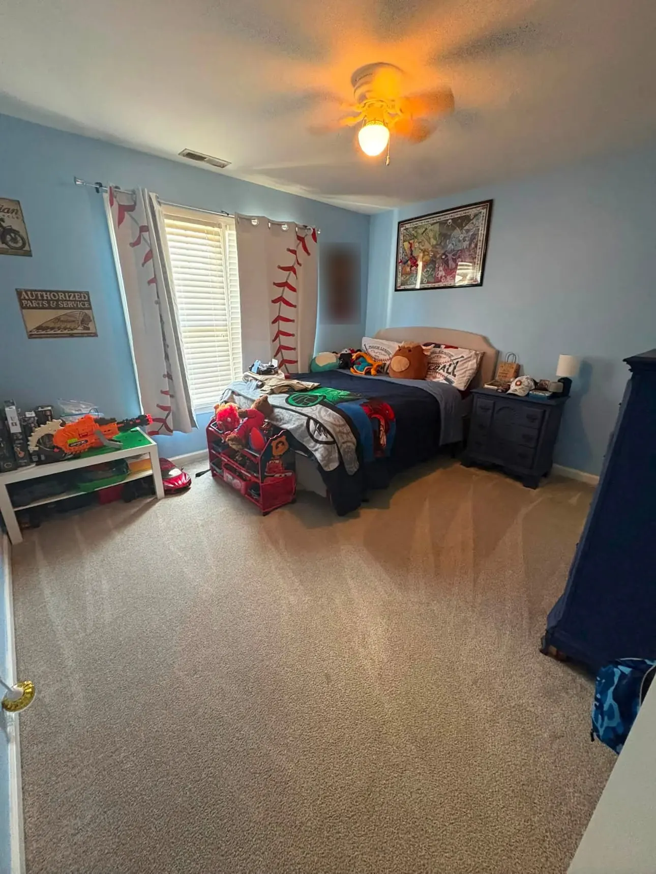 After: the same bedroom with a clear, freshly vacuumed carpet and the bed made