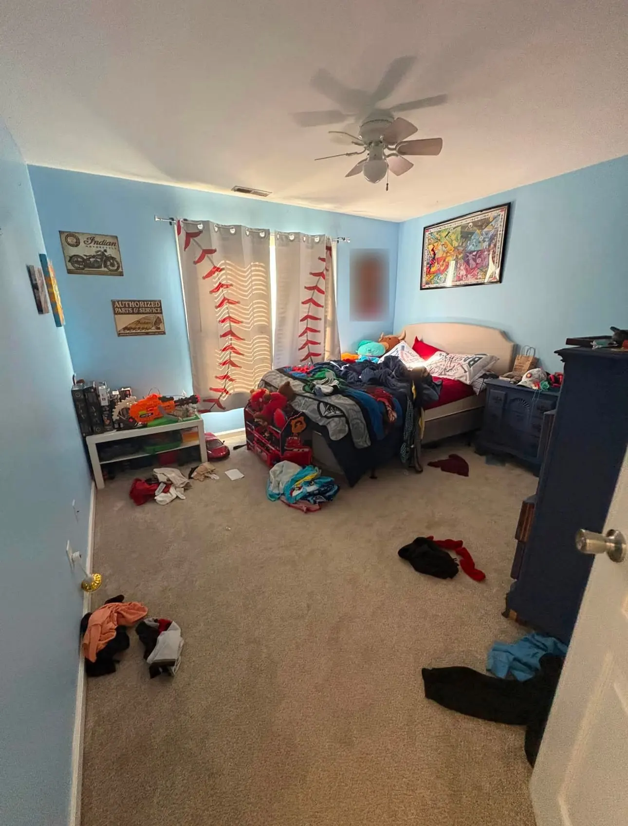 Before: bedroom with clothes scattered across the carpet and an unmade bed