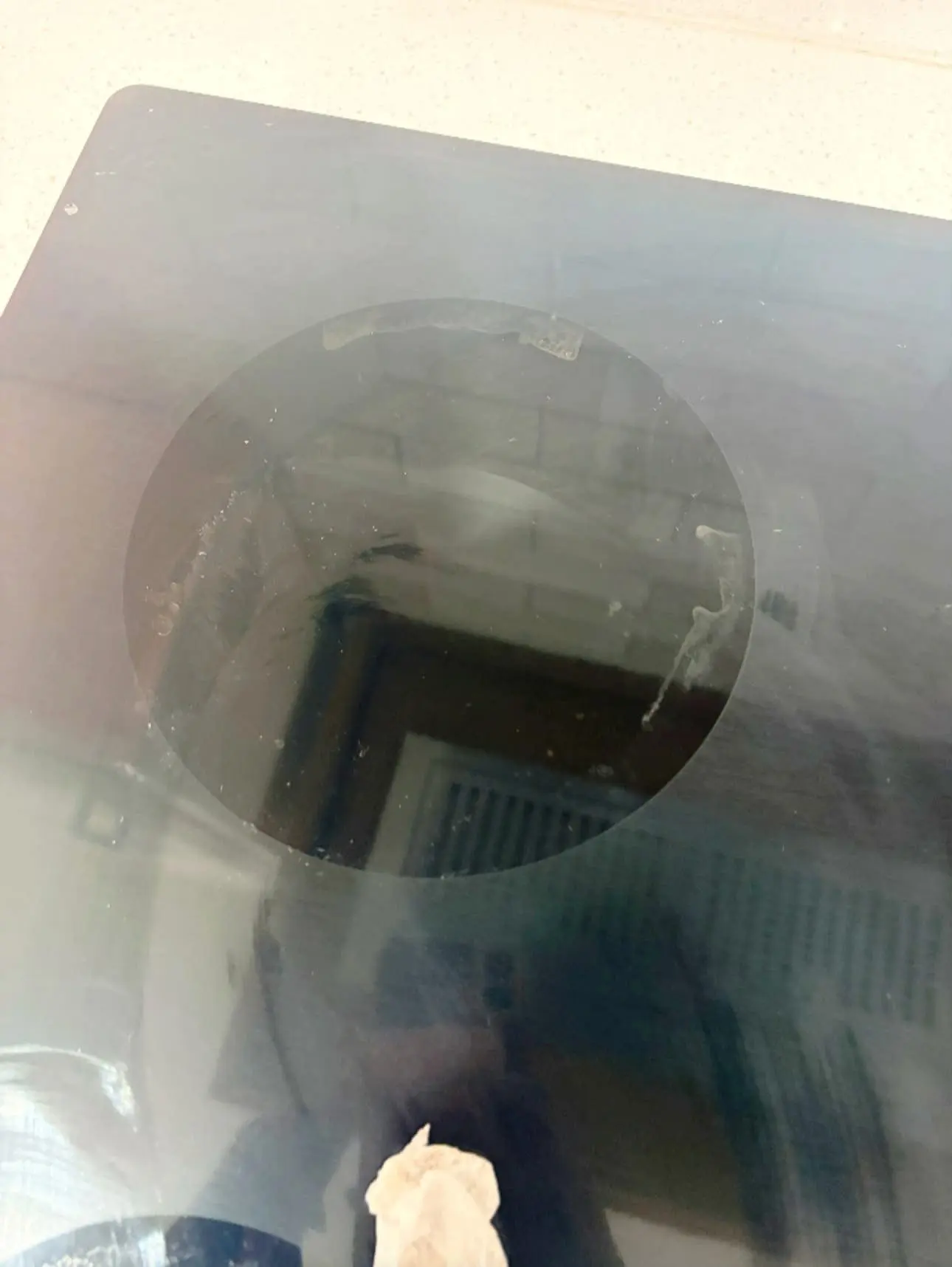 Before: glass cooktop burner ring with white residue and streaks